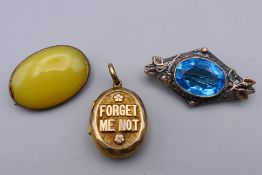 Two brooches and a 'Forget Me Not' locket. Locket 2.5 cm high.