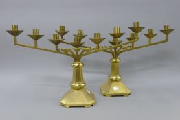 A pair of brass Menora candelabra. 59 cm wide.