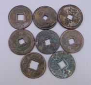 Eight Chinese coins. Each approximately 3.5 cm diameter.