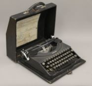 A vintage Oliver typewriter and an instruction booklet. 33.5 cm wide.