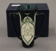 A boxed Moorcroft Snowdrop vase. 15 cm high.