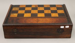 A 19th century inlaid games box set with ivory and ebony counters. 52 cm wide.