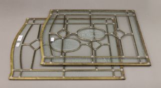 A pair of brass and glass panels. 41 x 53.5 cm.