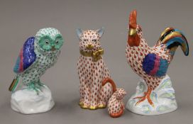 Four Herend porcelain models, a rooster, an owl and two cats. The former 14 cm high.