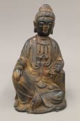 A bronze model of Buddha seated holding a scroll. 22 cm high.