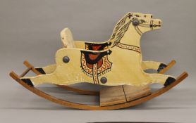 A painted wooden rocking horse. 87 cm long.