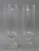 Two cut glass storm lamps. The largest 40 cm high.