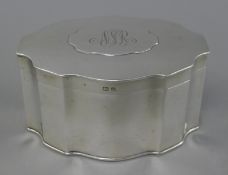 A silver tea caddy, Birmingham 1911. 15 cm wide. 478.8 grammes.