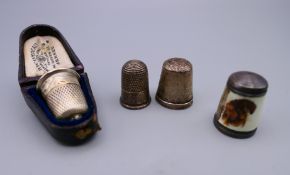 Two silver thimbles, an enamelled thimble depicting dachshunds and a boxed silver thimble.
