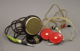 A vintage Omega white and red headphones and a bakelite Grundig microphone.