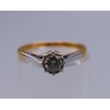 An 18 ct gold and diamond solitaire ring. Ring size L/M. 2.1 grammes total weight.