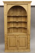 A 19th century and later pine barrel back corner cupboard. Approximately 223 cm high.