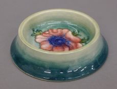 A Moorcroft Anemone bottle coaster. 13 cm diameter.