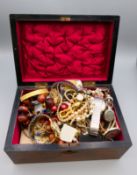 A quantity of costume jewellery in a wooden box.