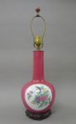 A Chinese pink porcelain lamp decorated with birds. 67 cm high overall.