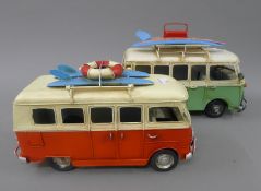 Two tin plate VW camper van models. The largest 25 cm long.