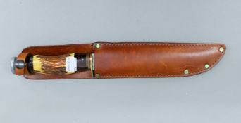 A WWII antler handled bowie knife in scabbard. 34 cm long.