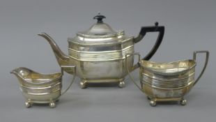 A silver three-piece tea set. The teapot 29 cm long. 854.6 grammes total weight.