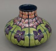 A Moorcroft Violets vase. 15 cm high.