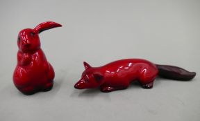 A Royal Doulton Flambe fox and a Flambe rabbit. The former 13.5 cm long.