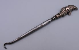 A silver Mr Punch button hook. 15.5 cm high.