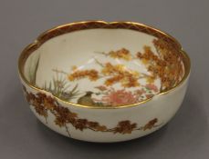 A Japanese Satsuma bowl painted with pheasant amongst trees, with two character seal mark to base.