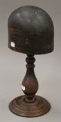 An antique hat block on a stand. 40 cm high.