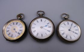 Three silver cased pocket watches. Largest 4 cm diameter.