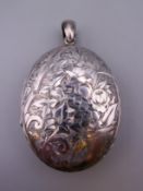 A large silver locket. 5 cm high excluding suspension loop. 28.7 grammes total weight.