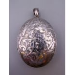 A large silver locket. 5 cm high excluding suspension loop. 28.7 grammes total weight.