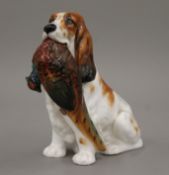 A Royal Doulton spaniel with pheasant, HN 1028. 13 cm high.