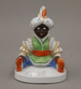 A Continental porcelain model of a seated boy. 13.5 cm high.