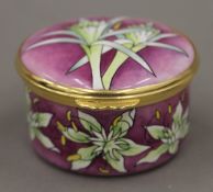 A boxed Moorcroft enamel Fuchsia box. 5.5 cm diameter.