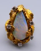 An 18 K gold opal and diamond ring. Ring size N/O (with sizer). 13.9 grammes total weight.