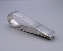 A large silver clip inscribed Alfred 1896. 10 cm long. 38.9 grammes.