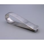 A large silver clip inscribed Alfred 1896. 10 cm long. 38.9 grammes.