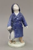 A Royal Copenhagen model of a boy with an umbrella. 18 cm high.