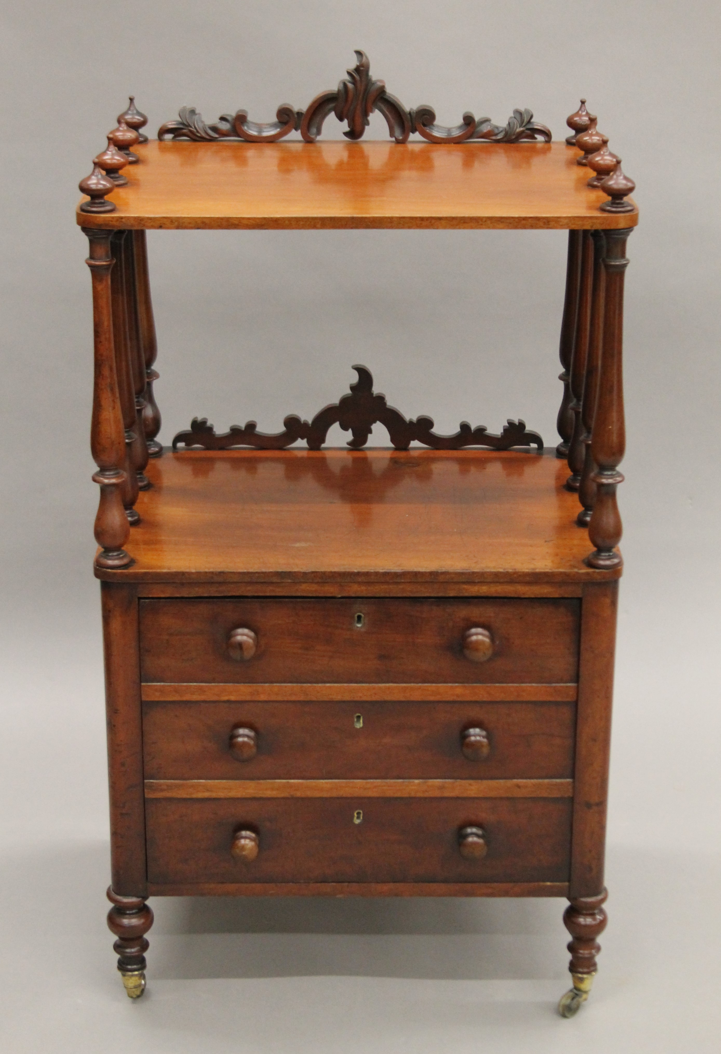 A Victorian mahogany whatnot with cellarette drawer. 102 cm high.