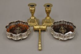 A brass gavel, a pair of brass dwarf candlesticks and a pair of silver plated bottle coasters.
