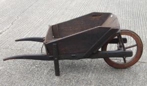 A 19th century wheelbarrow. Approximately 170 cm long.
