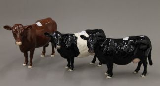 Three Beswick model cattle. The largest 15 cm high.