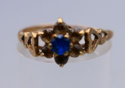 A 9 ct gold flowerhead ring. Ring size P/Q. 1.6 grammes total weight.