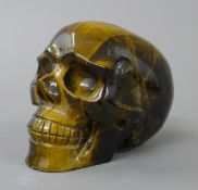 A tigerseye skull. 6 cm high.