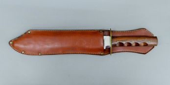 A Siege of the Alamo 1836 Commemorative bowie knife in scabbard. 41 cm long.