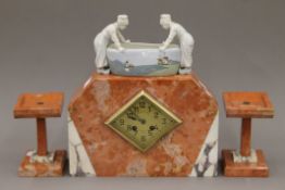 A French Art Deco marble and porcelain clock garniture. The clock 31 cm wide.