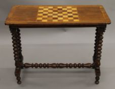 A Victorian inlaid walnut games table. 86 cm long.