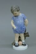 A Royal Copenhagen model of a boy with a teddy bear. 18 cm high.