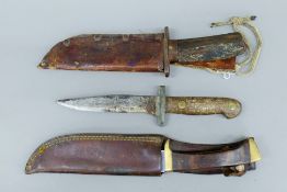 Three WWI period knives, two with scabbards. The largest 28 cm long.