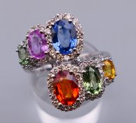 An 18 K white gold multi-colour sapphire and diamond ring. Ring size N/O. 7.3 grammes total weight.