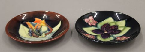 Two small Moorcroft dishes, Red Twilight and Violets, the latter boxed. The former 11.5 cm diameter.